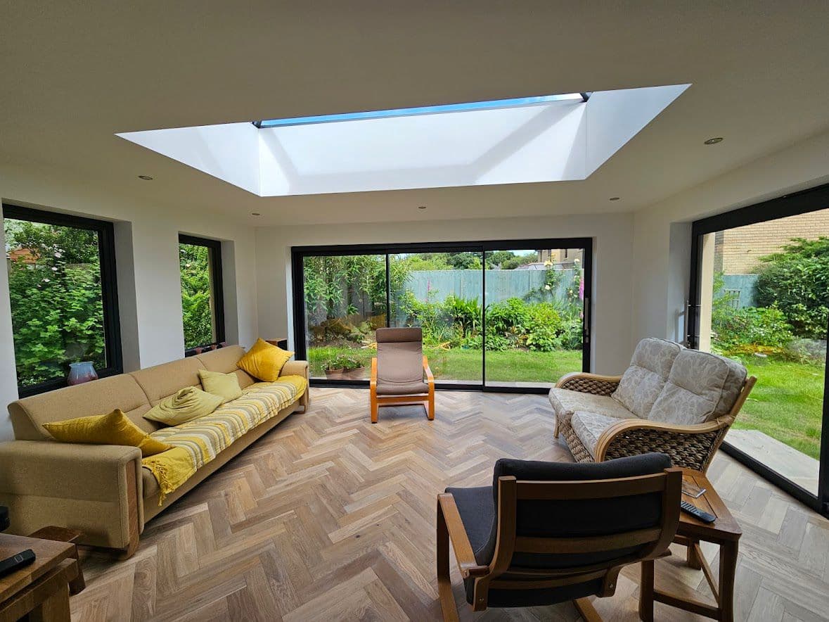 Modern house extension with full-width glazing to garden