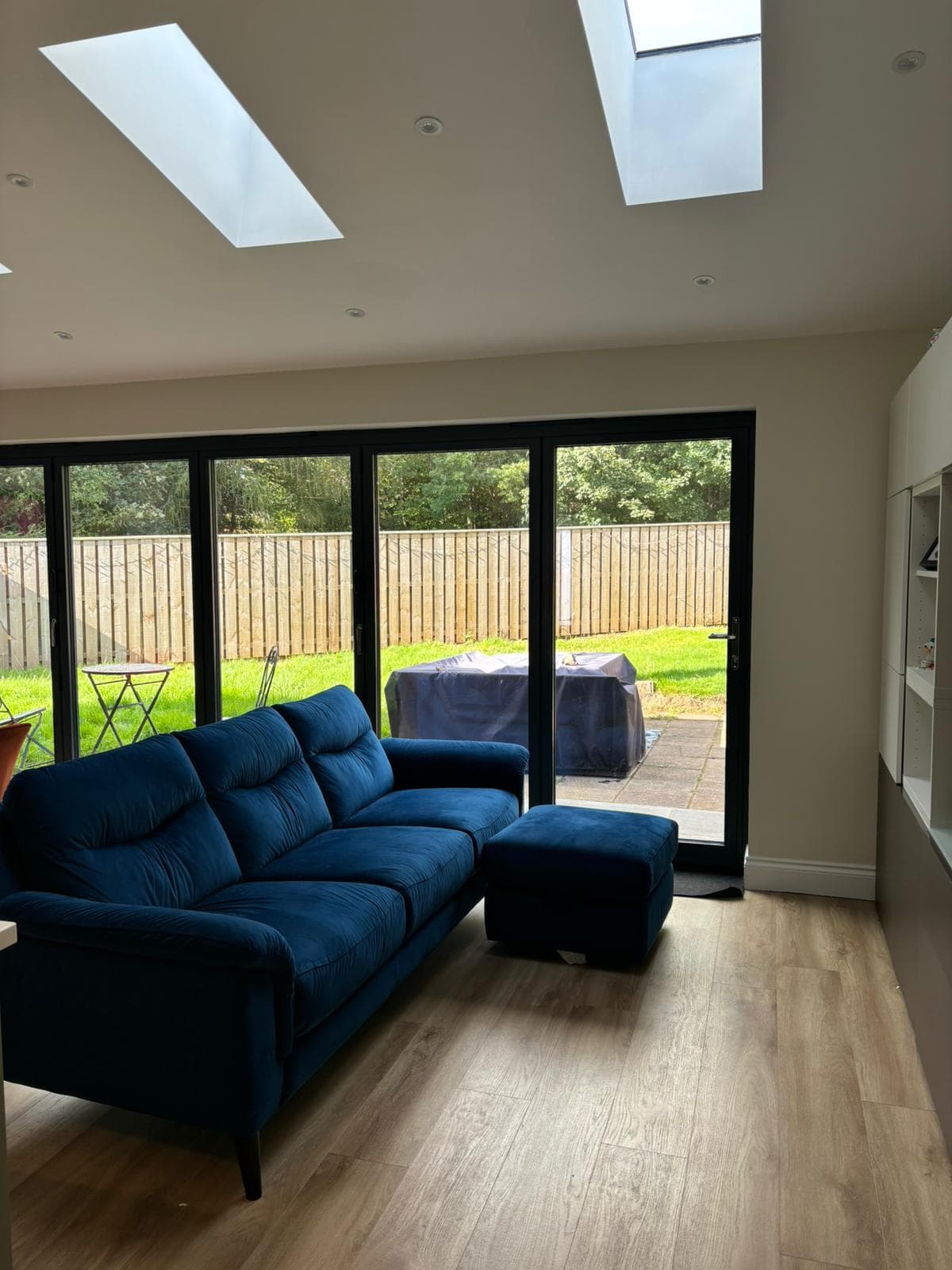 Bright extension dining and living space with sliding glass doors
