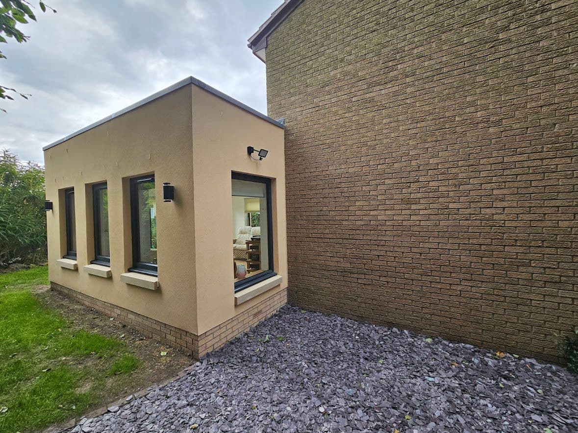 Sleek contemporary extension exterior with composite wood cladding