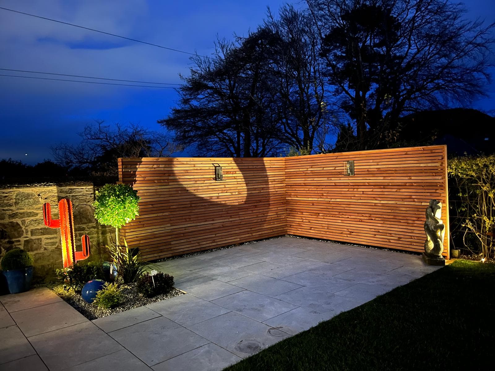 Contemporary cedar slatted boundary fencing and matching bench seat