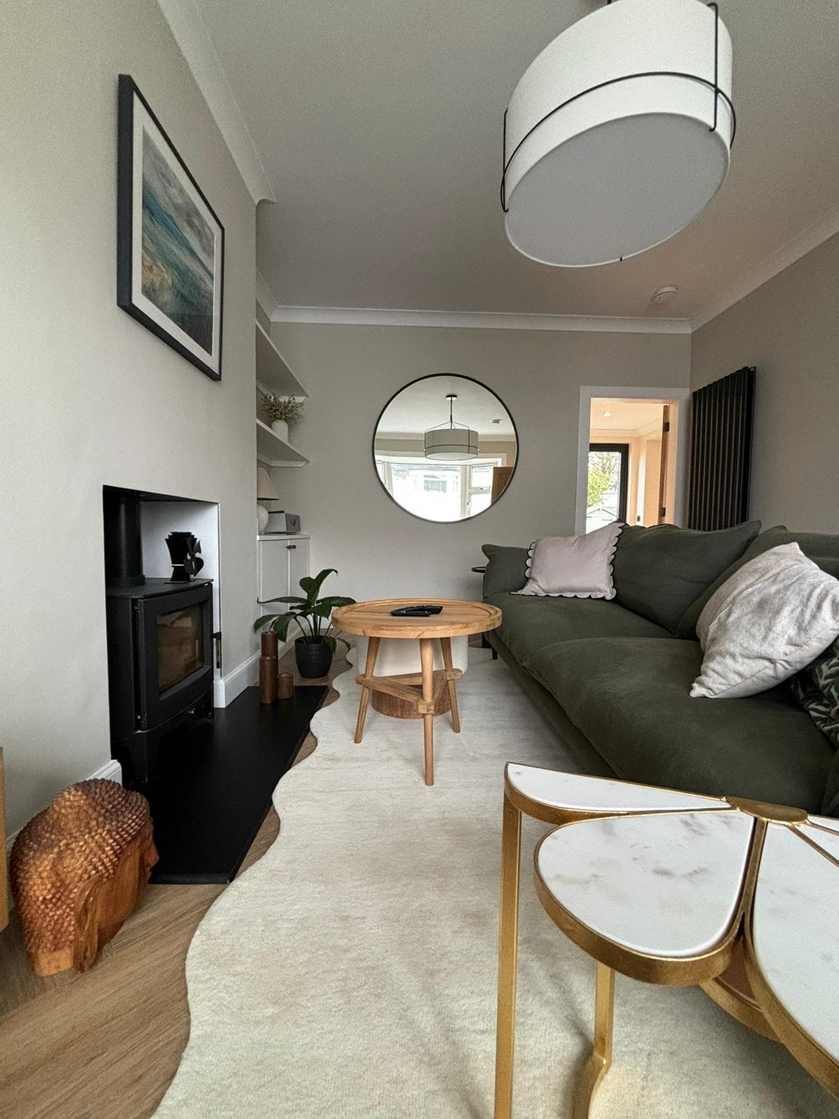 Cosy lounge renovation with inset wood burning fireplace and log storage
