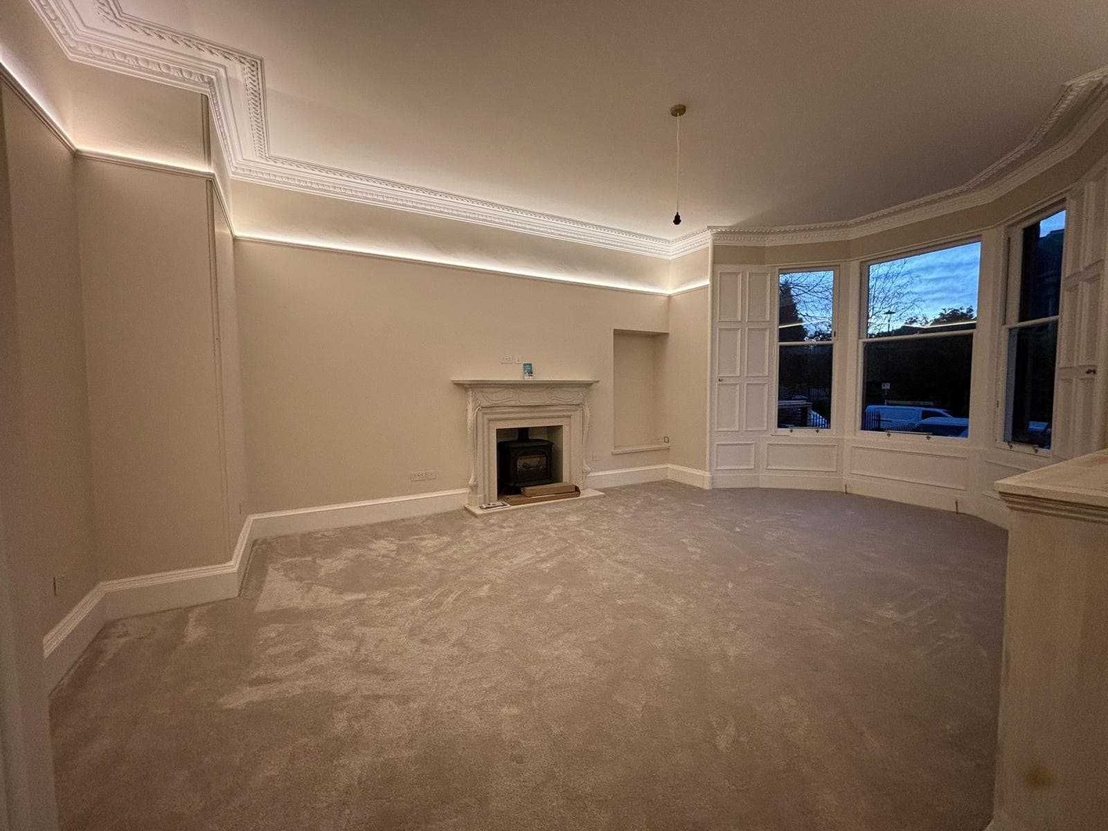 Elegant Victorian drawing room with restored ornate plaster cornices